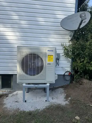Panasonic heat pump on a gravel pad